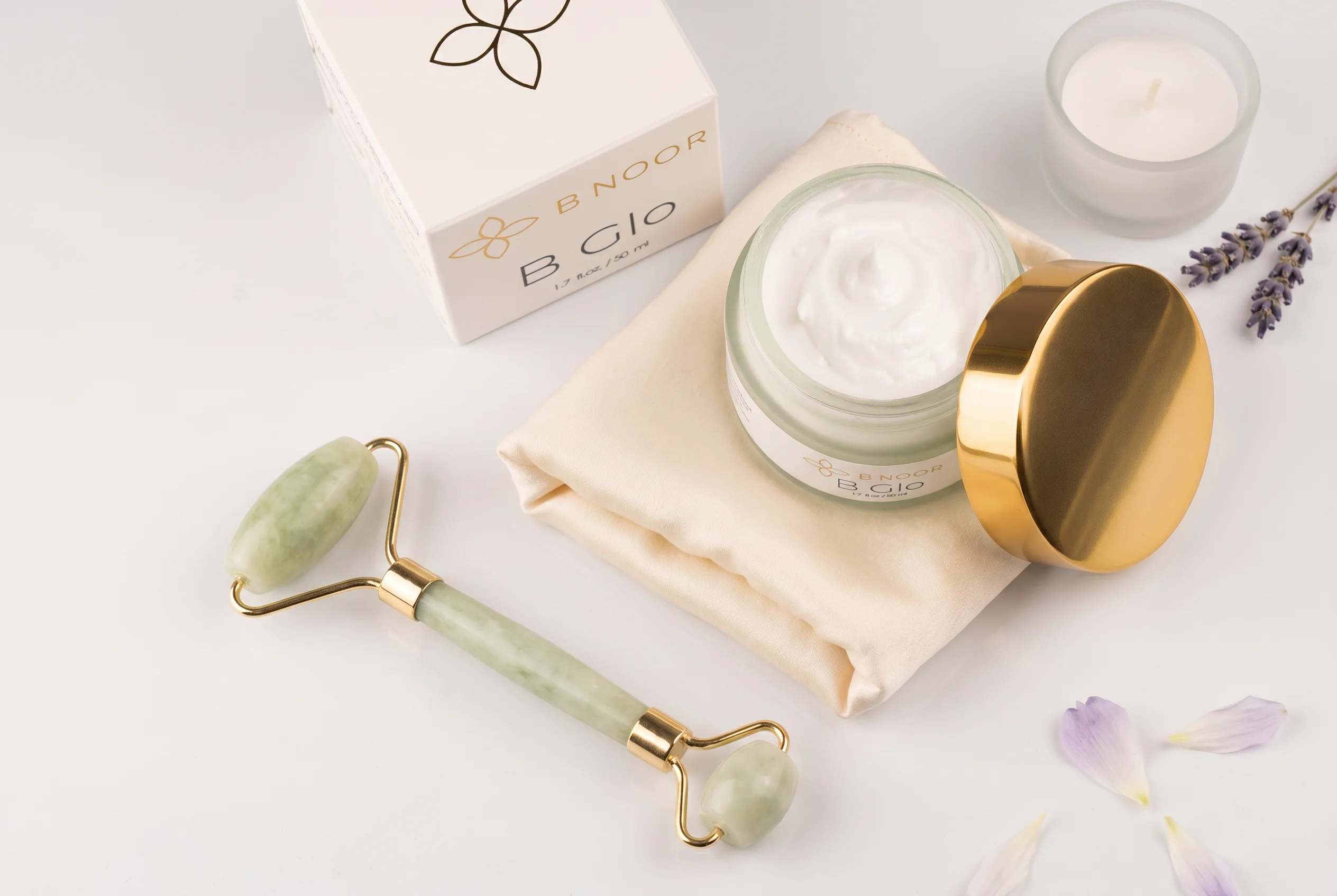 B NOOR B Glo hydrating cream with skincare essentials — luxury flat lay